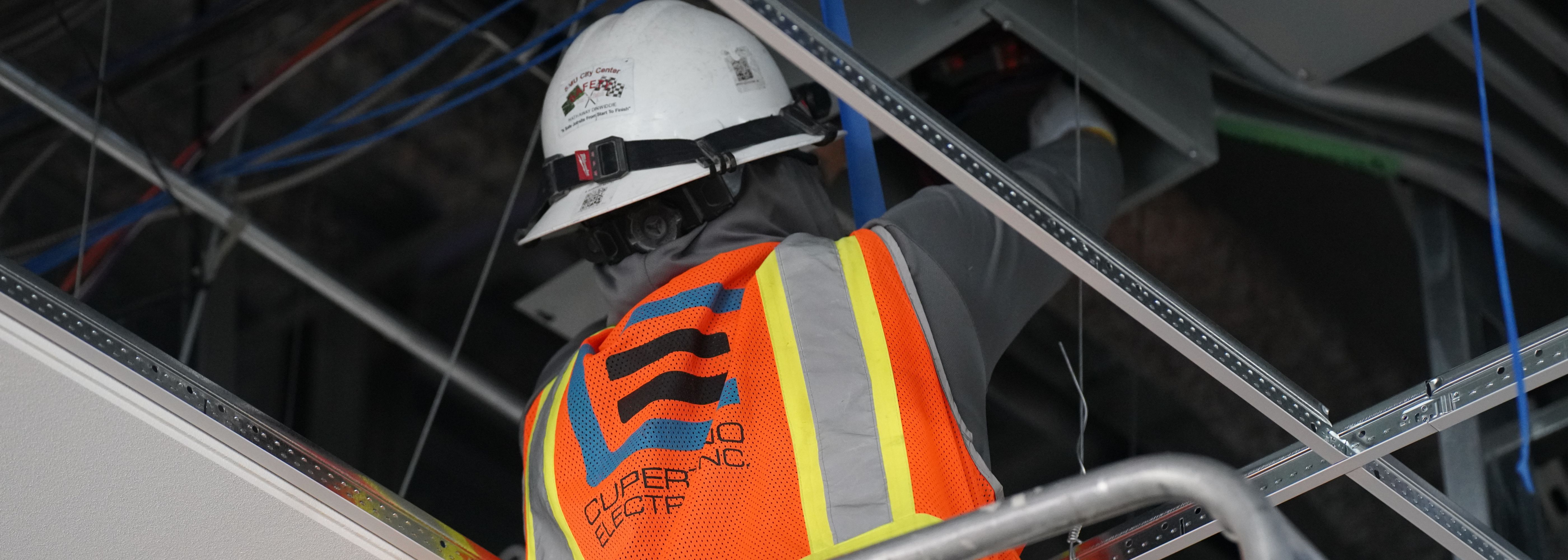 CEI worker installing conduit